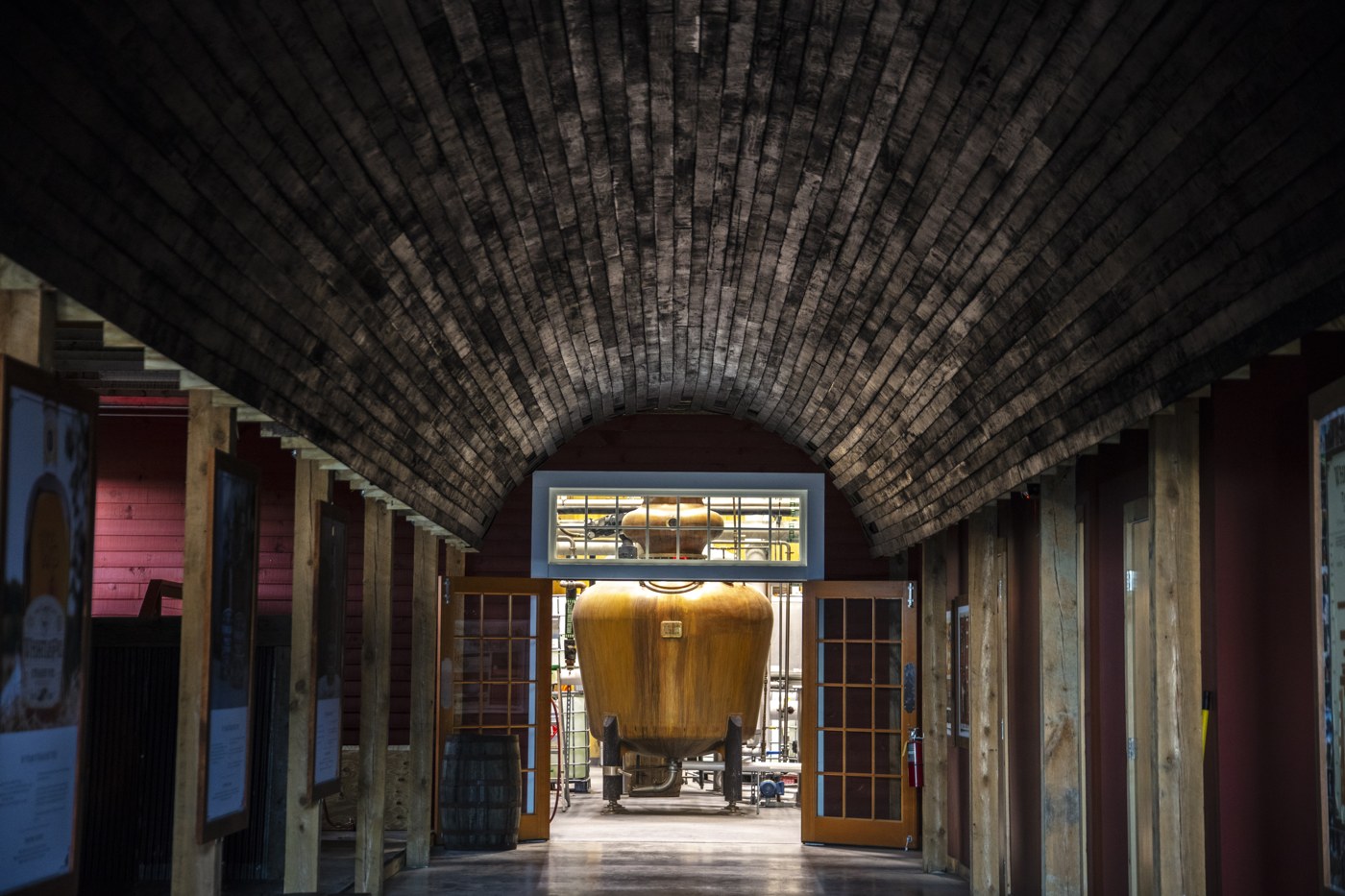 Copper still viewed through the WhistlePig distillery interior